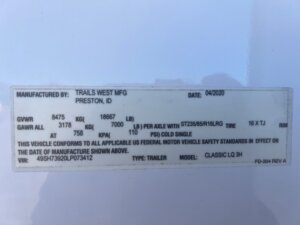 A white label with black text lists 3 Horse LQ vehicle specifications, including manufacturer (Trails West MFG, Preston, ID), date (04/2020), GVWR (8475 kg), GAWR (3178 kg per axle), tire size, and other compliance details. -Stillwater Trailer Sales