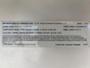 A white manufacturer’s label for an Elite 4 Horse trailer displays specifications including GVWR, GAWR, tire and rim sizes, cold tire pressure, VIN, and compliance information in English and French. -Stillwater Trailer Sales