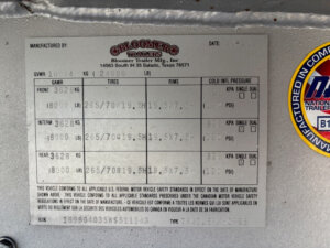 A metal information plate on the Bloomer horse trailer displays specifications like manufacturer details, GVWR, tire and rim sizes, pressures, and VIN. The plate is labeled &ldquo;Bloomer Trailers&rdquo; and contains both English and metric units. Ideal for a 5 horse trailer. -Stillwater Trailer Sales