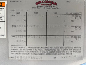 A trailer specification label for a Bloomer 5 Horse Side Load, showing weight limits, tire sizes, pressure info, VIN, and manufacturer details from Bloomer Trailer Mfg. Inc., Salado, Texas. The label is dated 10/21/23. -Stillwater Trailer Sales